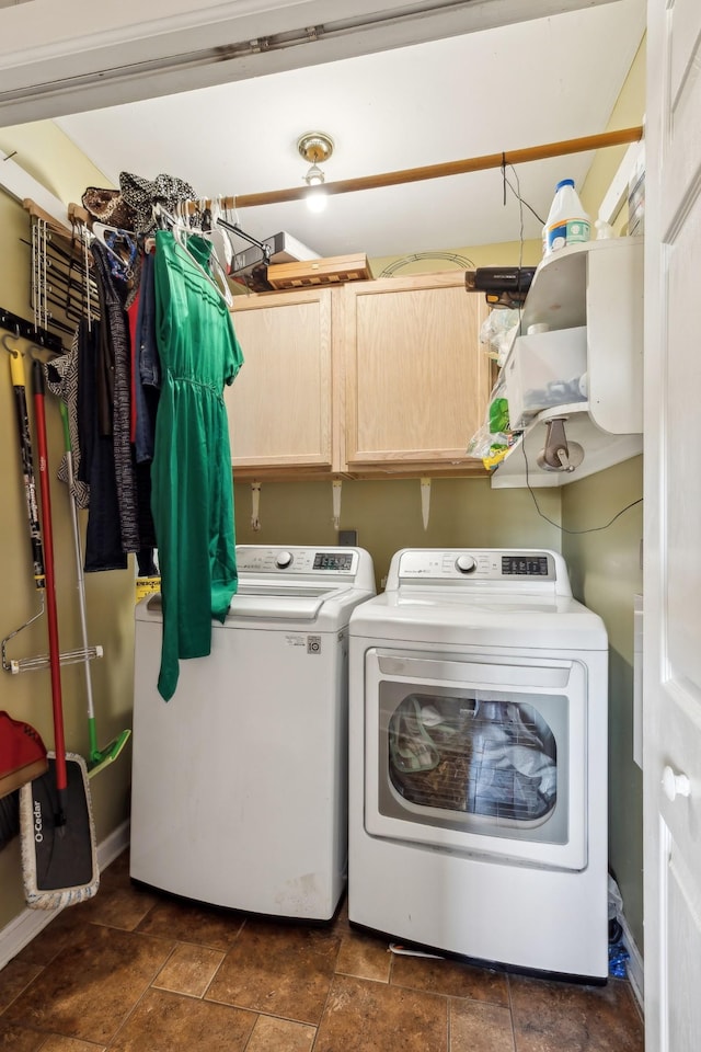 laundry area featuring cabinet space and washing machine and clothes dryer