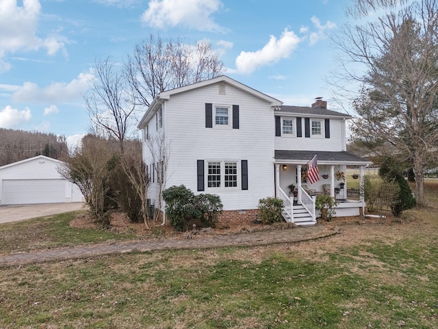 traditional home featuring a detached garage, a chimney, a porch, an outdoor structure, and a front lawn