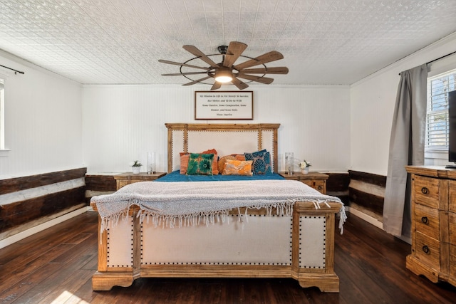 bedroom with crown molding, ceiling fan, and dark wood-type flooring