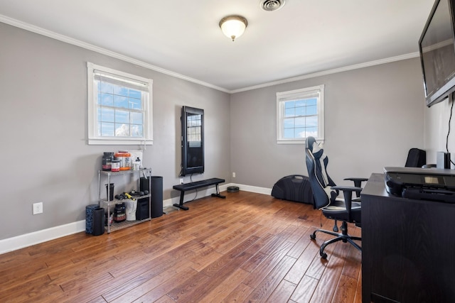 home office with baseboards, wood finished floors, and crown molding