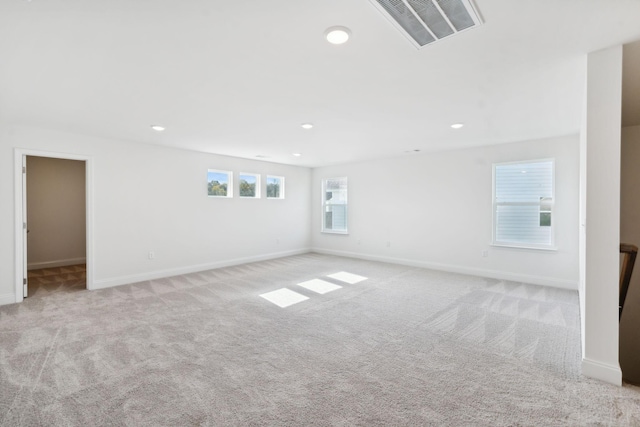 spare room with light carpet, baseboards, visible vents, and recessed lighting