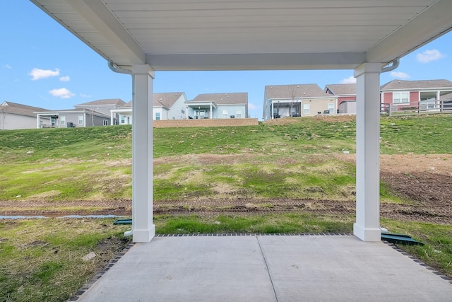 view of yard with a residential view and a patio