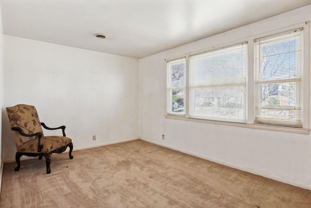 sitting room featuring visible vents, light colored carpet, and baseboards