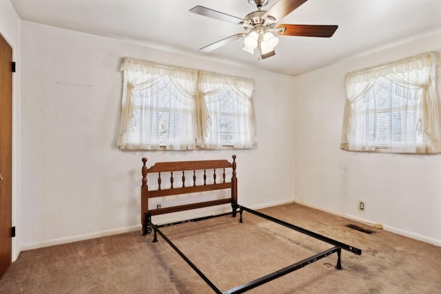 bedroom with multiple windows, baseboards, and carpet floors