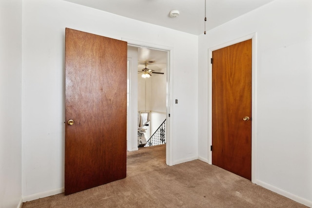 unfurnished bedroom with baseboards and carpet