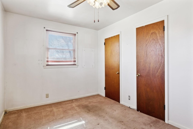 unfurnished bedroom featuring baseboards, carpet, and a ceiling fan