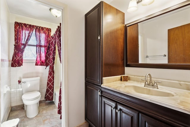 bathroom with toilet, tile walls, shower / tub combo with curtain, and vanity