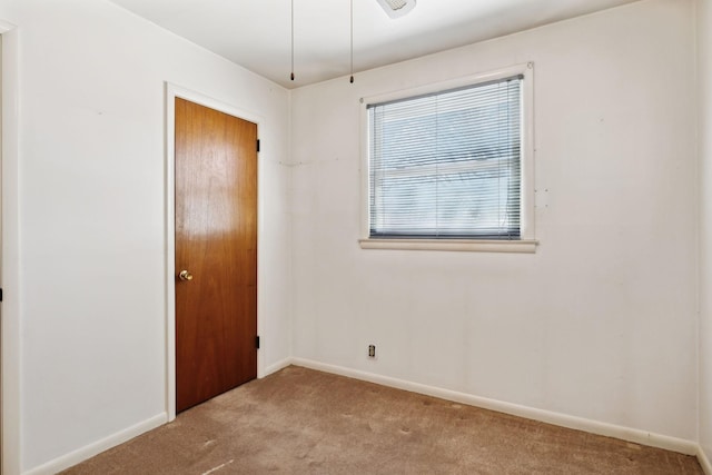 empty room with carpet flooring and baseboards