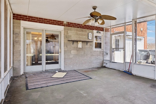 unfurnished sunroom featuring a wealth of natural light and ceiling fan