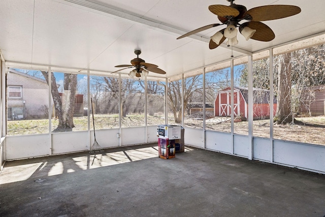 unfurnished sunroom featuring a ceiling fan