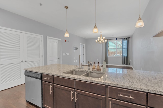 kitchen with light stone counters, dark brown cabinetry, a sink, stainless steel dishwasher, and decorative light fixtures