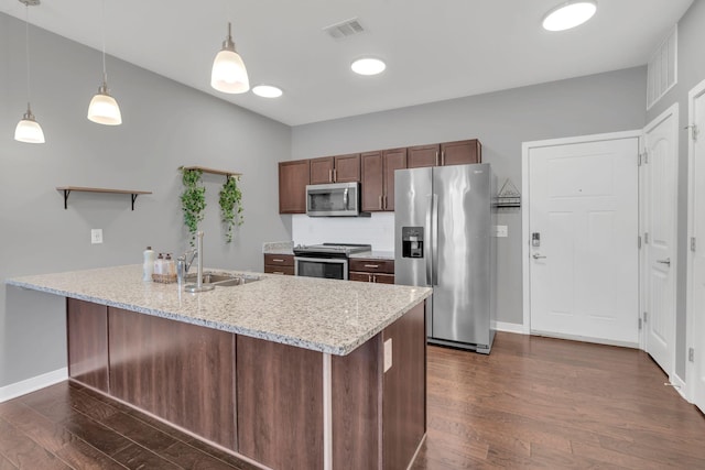 kitchen with dark wood-style flooring, open shelves, stainless steel appliances, visible vents, and a sink