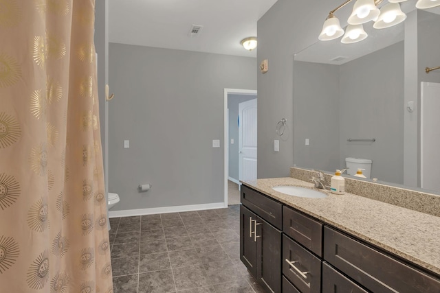 full bathroom with visible vents, toilet, vanity, baseboards, and tile patterned floors