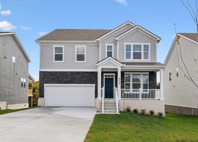 craftsman-style house featuring a porch, concrete driveway, a front lawn, and a garage