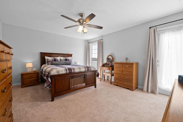 bedroom featuring a ceiling fan and light colored carpet