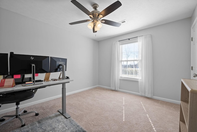 home office featuring a ceiling fan, carpet, visible vents, and baseboards