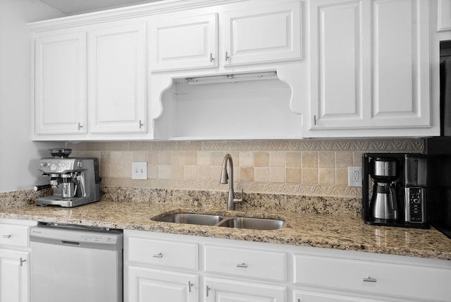 kitchen with decorative backsplash, stainless steel dishwasher, white cabinets, a sink, and light stone countertops