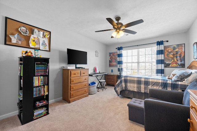 bedroom with ceiling fan, carpet floors, and baseboards