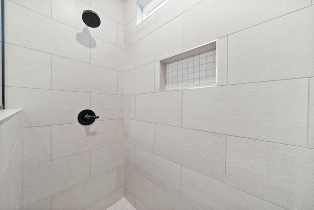 bathroom with tiled shower