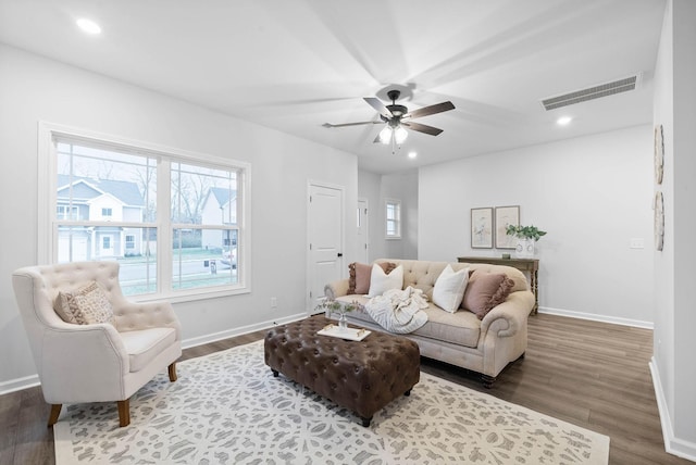 living area with baseboards, wood finished floors, visible vents, and recessed lighting