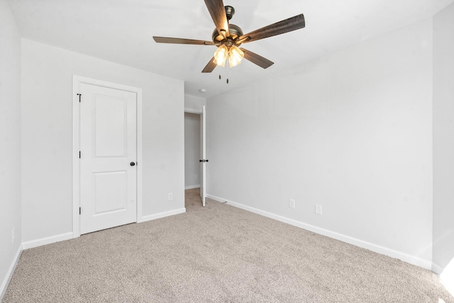 unfurnished bedroom with carpet, a ceiling fan, and baseboards