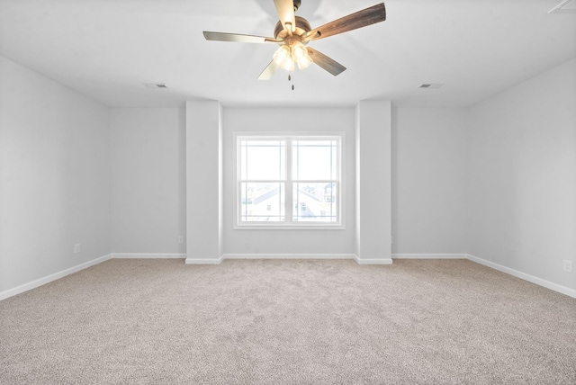 unfurnished room with light carpet, baseboards, visible vents, and a ceiling fan