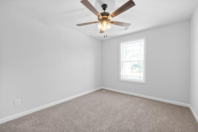 spare room featuring a ceiling fan, baseboards, visible vents, and carpet flooring