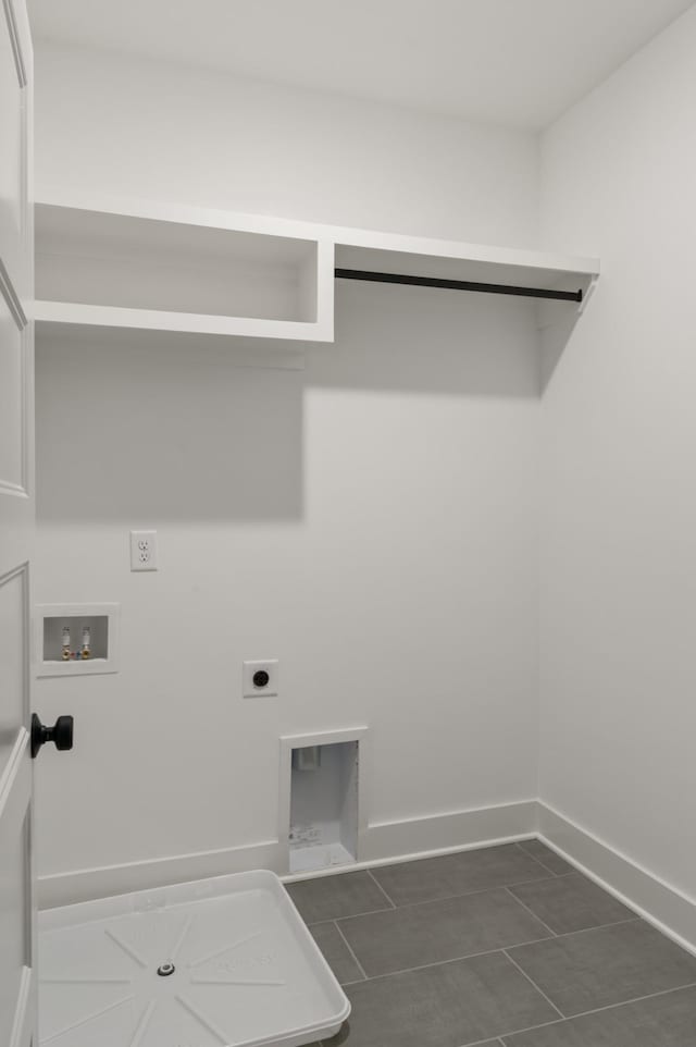 clothes washing area featuring washer hookup, hookup for an electric dryer, laundry area, dark tile patterned floors, and baseboards