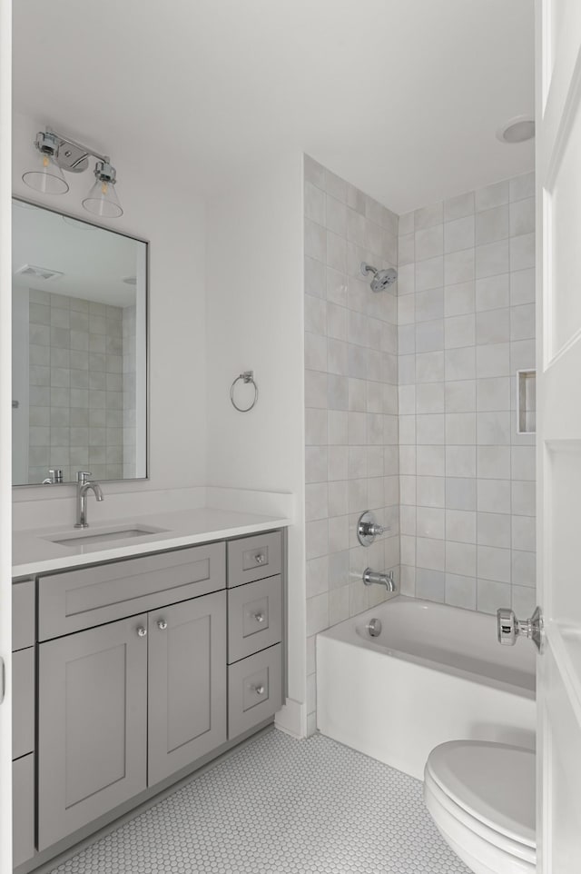 full bath featuring toilet, vanity, visible vents, and bathing tub / shower combination