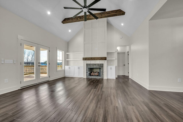 unfurnished living room with dark wood-style floors, french doors, a fireplace, and baseboards