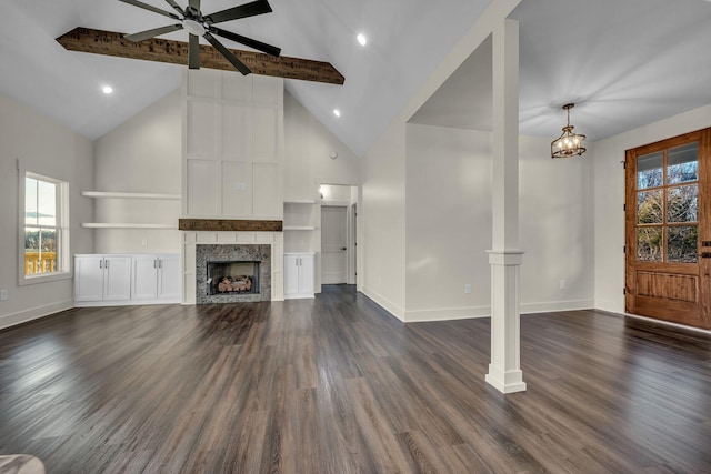 unfurnished living room with baseboards, a fireplace, high vaulted ceiling, and dark wood finished floors