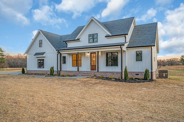 modern inspired farmhouse featuring crawl space, a shingled roof, a porch, and board and batten siding