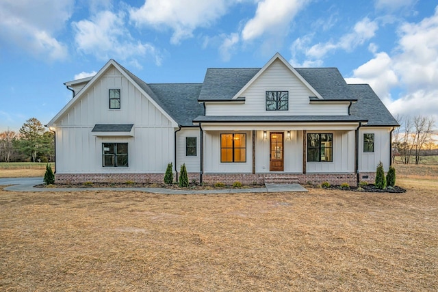 modern inspired farmhouse featuring board and batten siding, crawl space, roof with shingles, and a porch