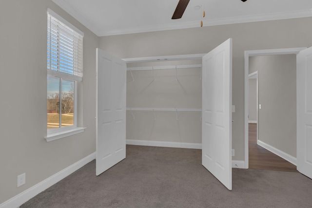 unfurnished bedroom with baseboards, crown molding, and carpet