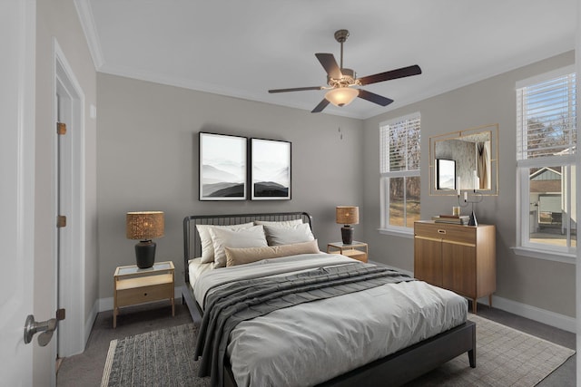 carpeted bedroom with baseboards, ceiling fan, and crown molding