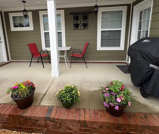 view of patio featuring covered porch and a grill