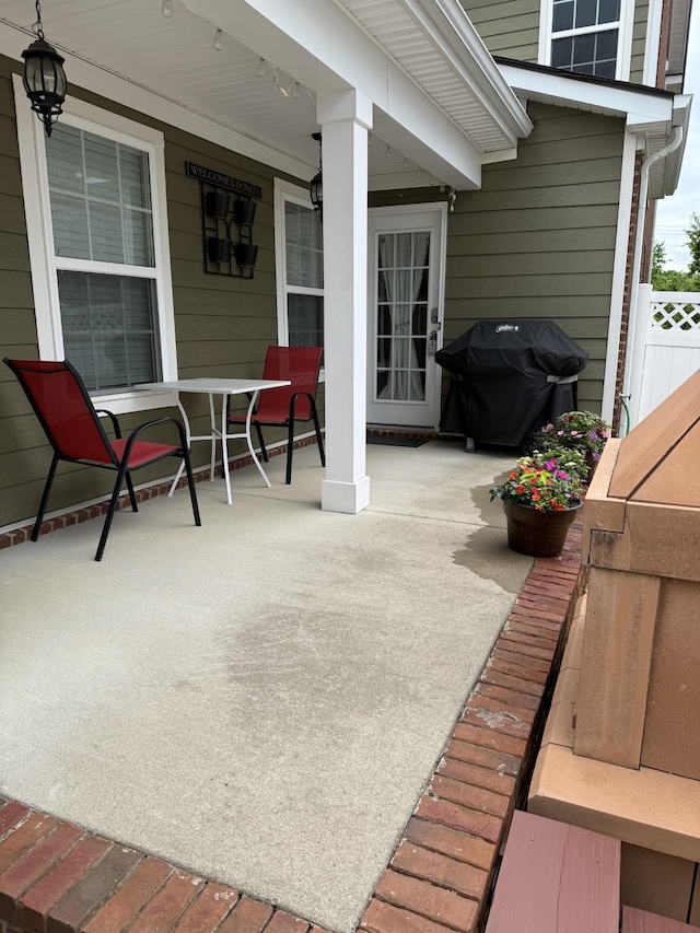 view of patio featuring covered porch and a grill