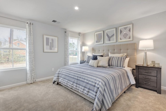 bedroom with light carpet, recessed lighting, visible vents, and baseboards