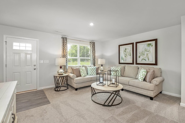 living area featuring recessed lighting, light colored carpet, visible vents, and baseboards