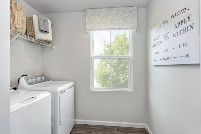 laundry area featuring laundry area, baseboards, washer and clothes dryer, and wood finished floors