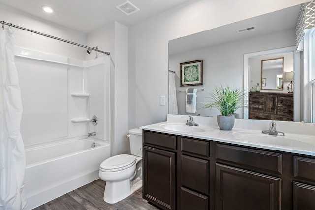 full bathroom with toilet, visible vents, and a sink