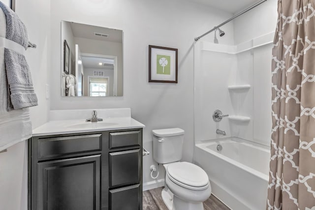 bathroom with shower / bath combination with curtain, visible vents, toilet, vanity, and wood finished floors