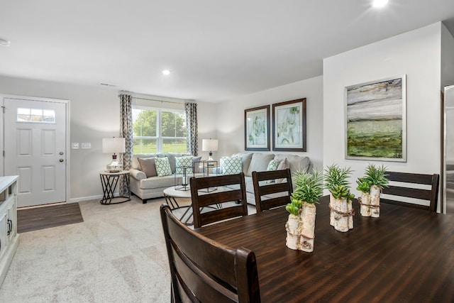 dining area with recessed lighting, light carpet, and baseboards