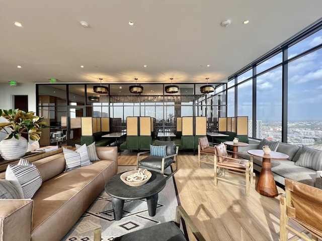 living area featuring recessed lighting, light wood-type flooring, and floor to ceiling windows