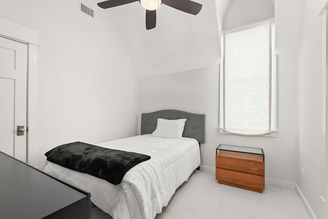 bedroom with ceiling fan, carpet flooring, visible vents, baseboards, and vaulted ceiling