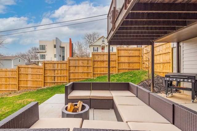 view of patio featuring area for grilling, a fenced backyard, and an outdoor living space