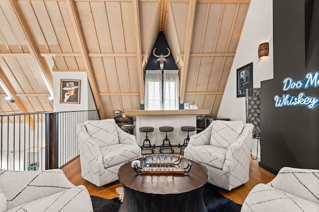 living room featuring lofted ceiling with beams and wood finished floors