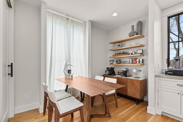 dining area with light wood finished floors, baseboards, and recessed lighting