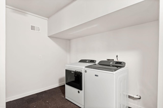 clothes washing area featuring laundry area, visible vents, baseboards, and separate washer and dryer