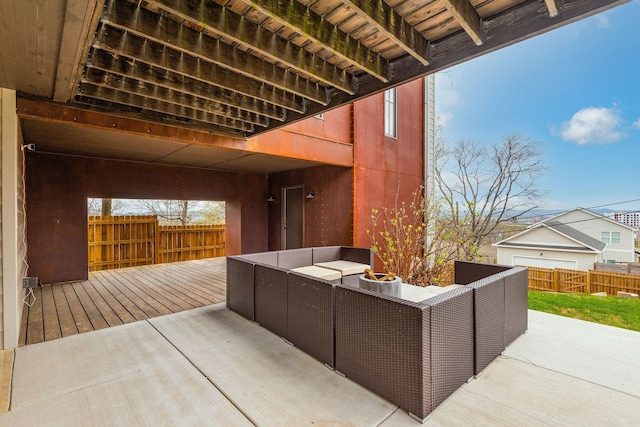 view of patio with outdoor lounge area, a wooden deck, and fence